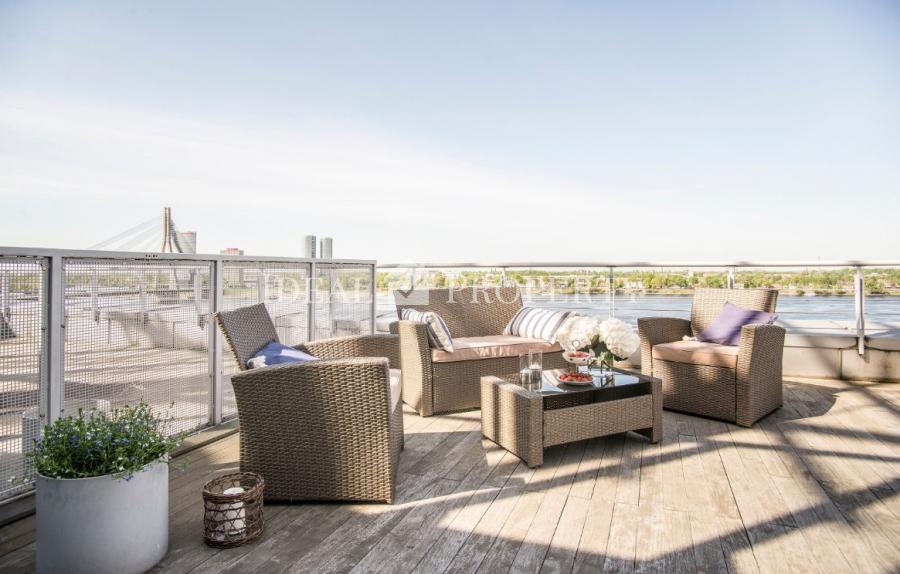 Exclusive two-storey penthouse with floor-to-ceiling windows offers the amazing view to Daugava river. 