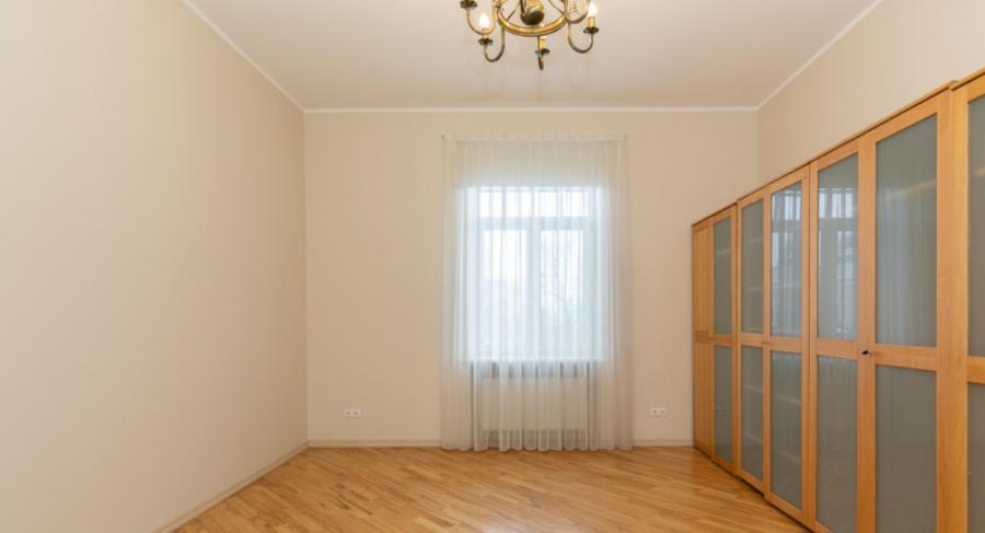 Spacious living room with large windows facing the Daugava River. 