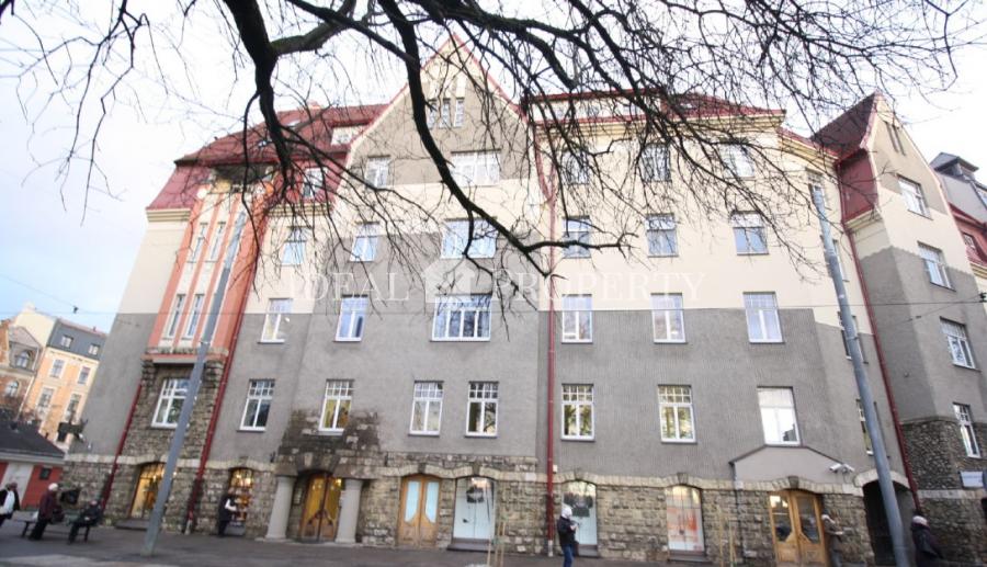 Spacious living room with large windows facing the Daugava River. 