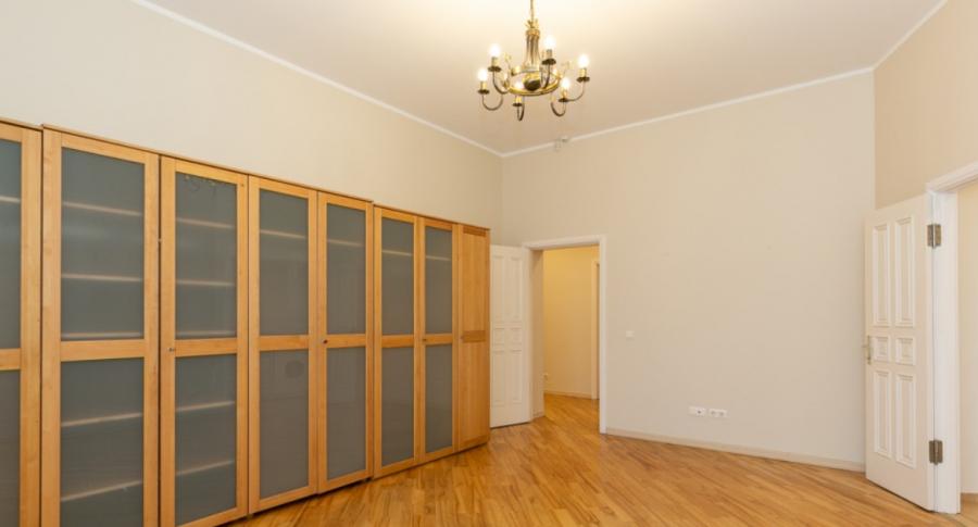 Spacious living room with large windows facing the Daugava River. 