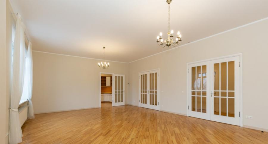 Spacious living room with large windows facing the Daugava River. 