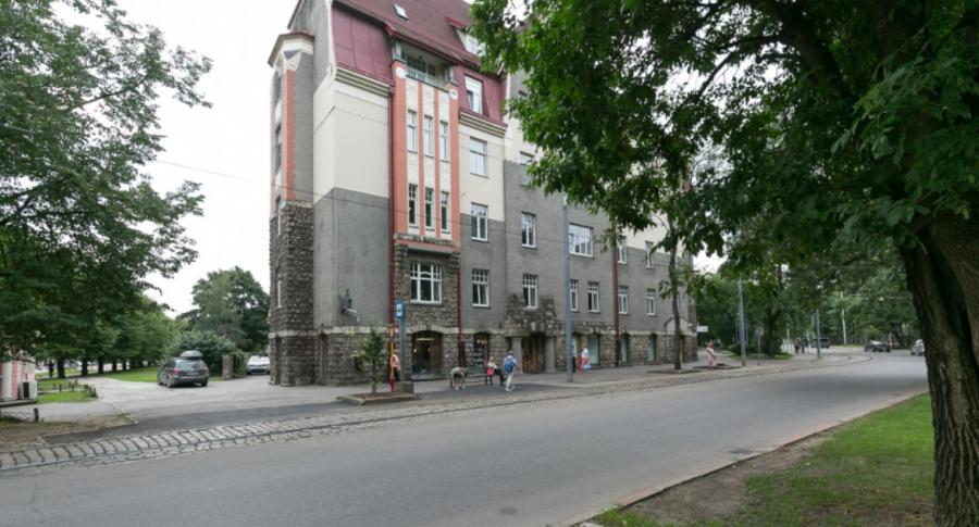 Spacious living room with large windows facing the Daugava River. 