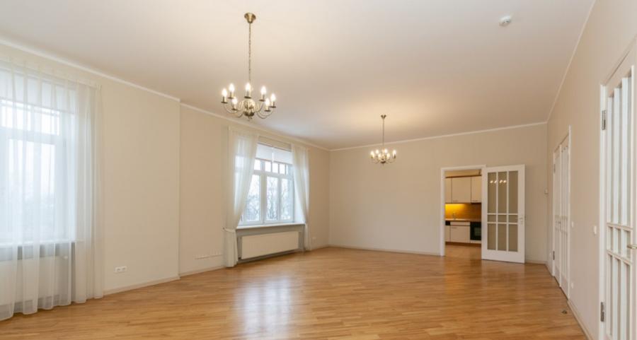 Spacious living room with large windows facing the Daugava River. 