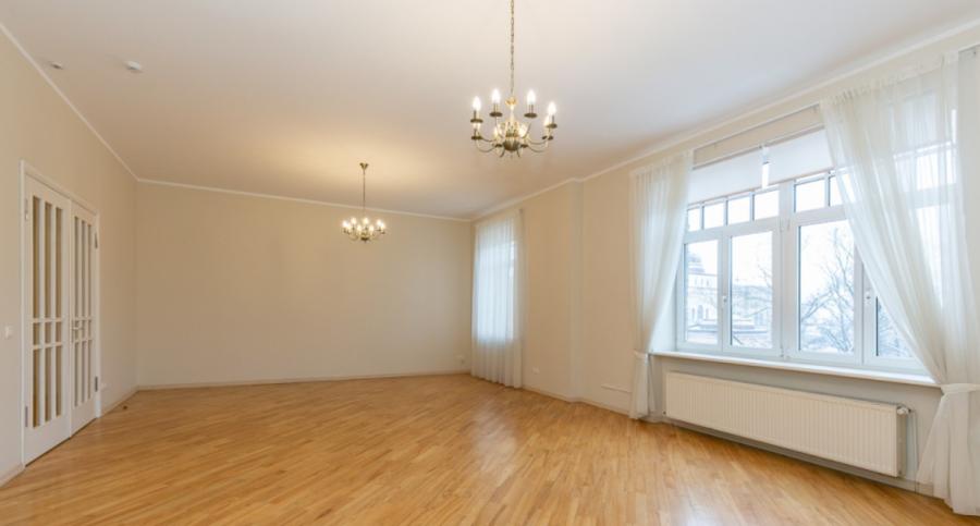 Spacious living room with large windows facing the Daugava River. 