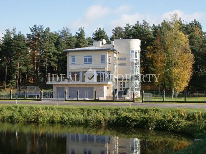 The house is surrounded by landscaped, green area, situated near the beautiful pine forest.